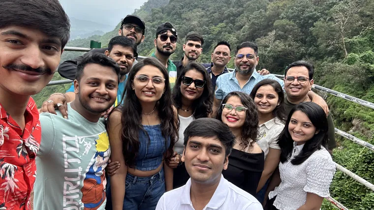 TechnoBrains team members taking a group selfie at a hill viewpoint
